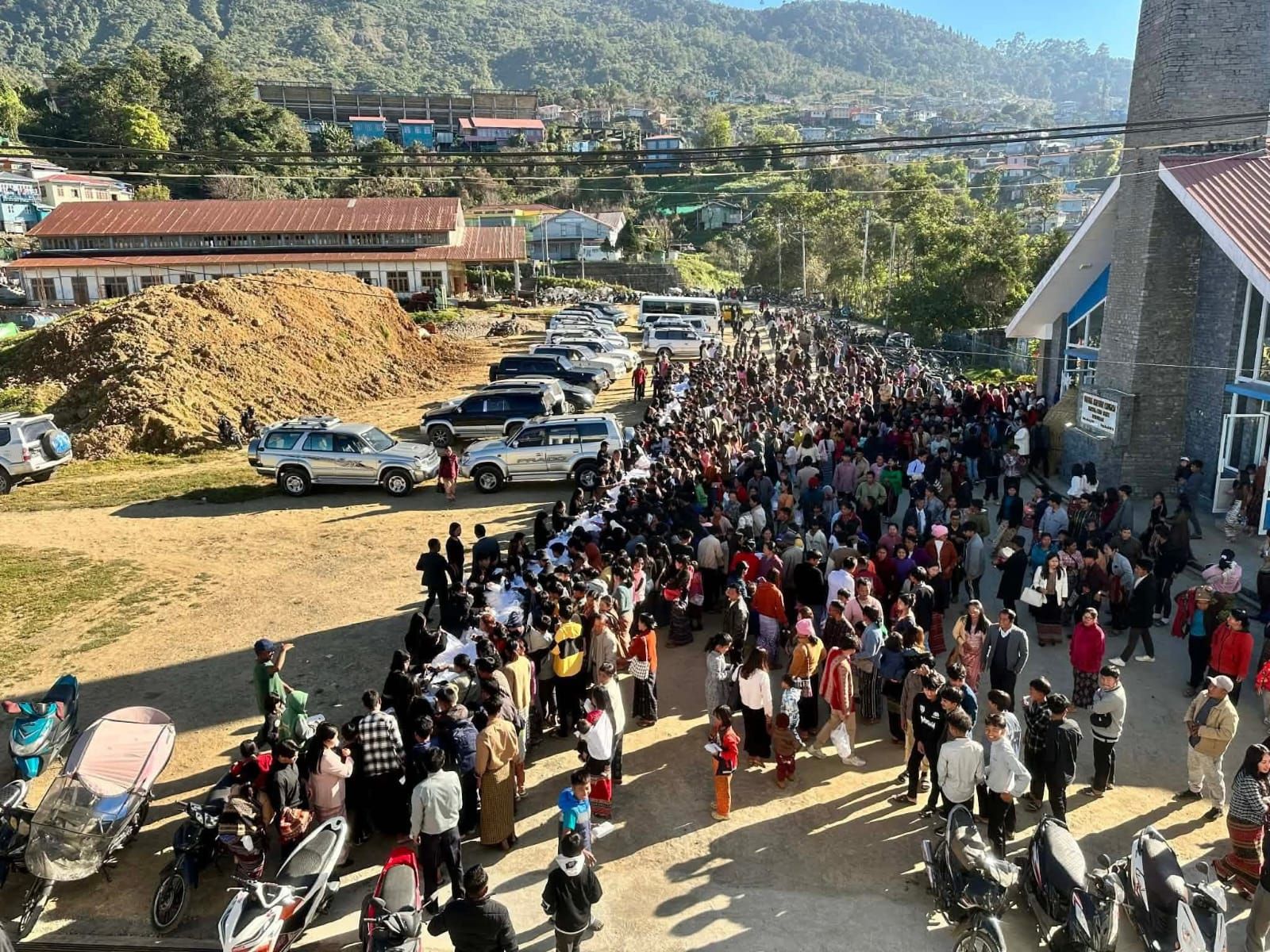 People having dinner after church service in front of the Hakha Baptist Church building in Hakha (Photo: CG)