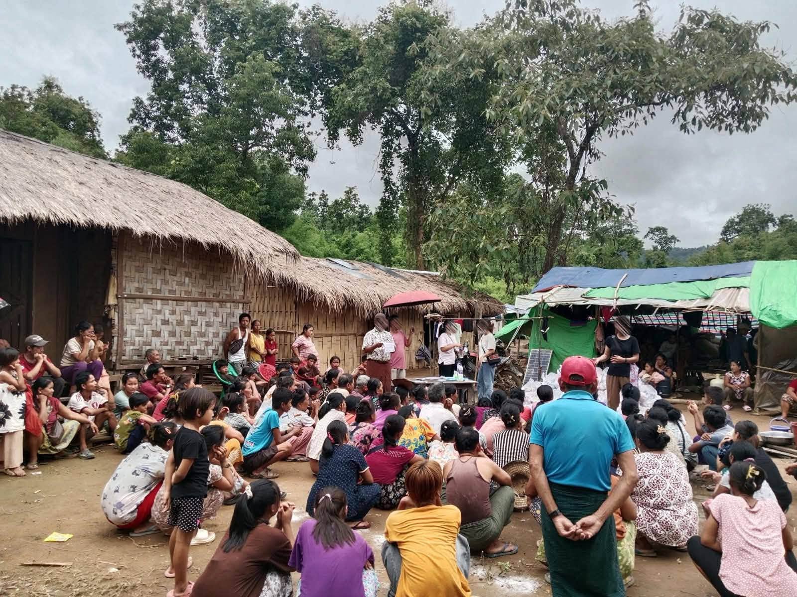 Displaced civilians at a temporary camp near the India-Myanmar border receiving humanitarian aid from KWHRO (Photo: Facebook/Zalen)